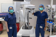 Shari Meyerson, M.D. (left) and Mansi Shah, M.D. (right) stand on either side of the Da Vinci robot