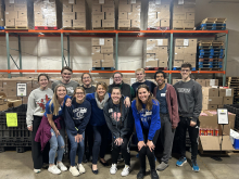 students and campus leadership pose as a group after volunteering at GoPantry