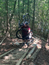 Greg Graf ascends stairs with a mountain bike. 