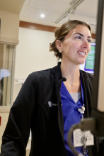 An ICU worker is stationed at her desk