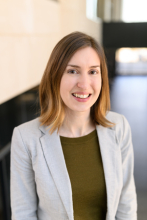 Woman in gray blazer and green top