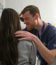 Smith, a student volunteer at the Salvation Army Clinic, is pictured performing a patient exam. 