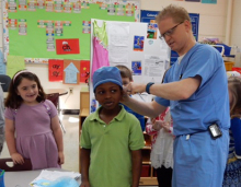 Skinner tying OR caps on kids2.jpg