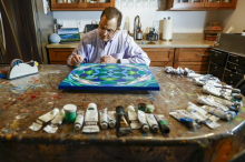 D'Orazio working on a painting in his workshop.