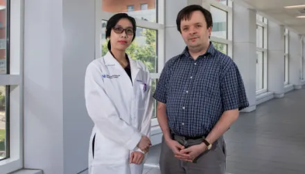 Martha Sims, MD and Jeremy Wood, PhD standing in a hallway