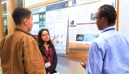 Undergraduate student presenting a poster.