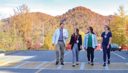 students walking on a street with mountains behind them