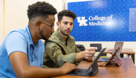 Two students studying together using an iPad 