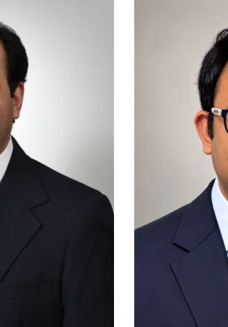 Headshot of Asadipooya and Kundu next to one another. They each wear a suit and tie.