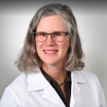 Dr Sandra Beck posing in a white coat