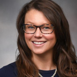 Woman in black shirt with glasses