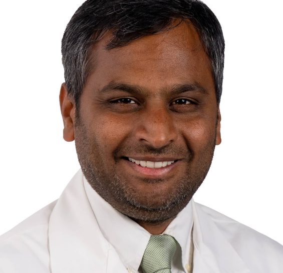 Headshot of man in white shirt and green tie