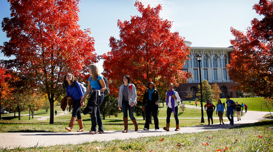 Students walking across campus in fall.