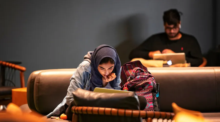 Female student working in library.