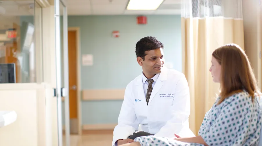 doctor and patient talking a patient bedside