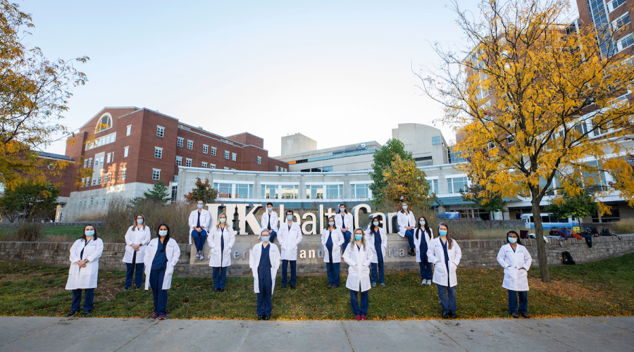 group of medical residents in front of UK HealthCare sign