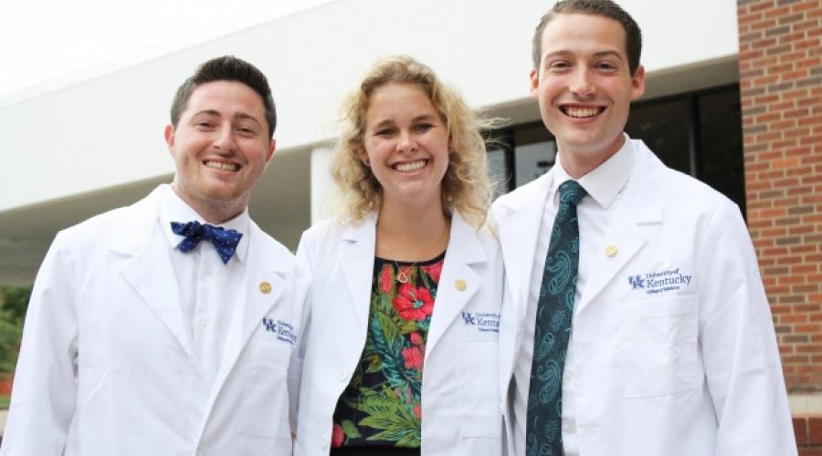 UK students posing for a picture in their white coats