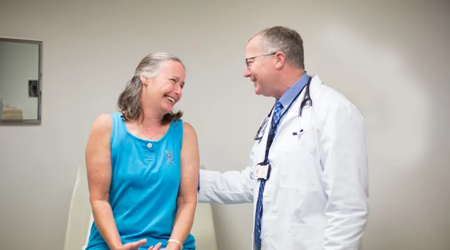 doctor speaking with patient on examination table