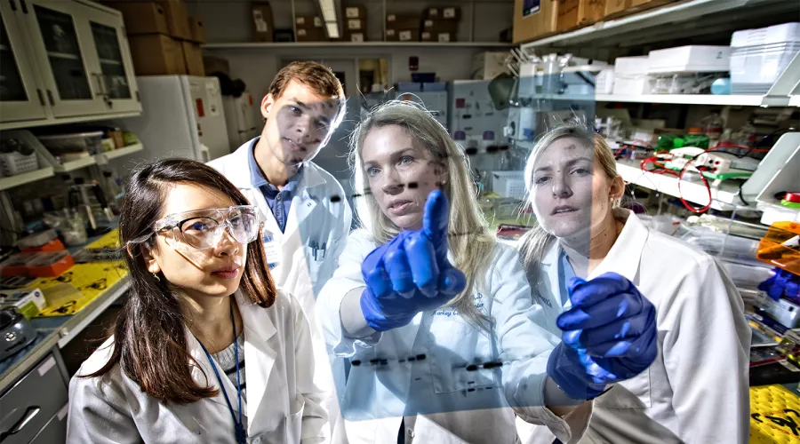 Professor in a lab with students