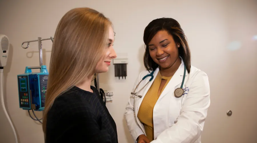 Woman having blood pressure checked by a female doctor.
