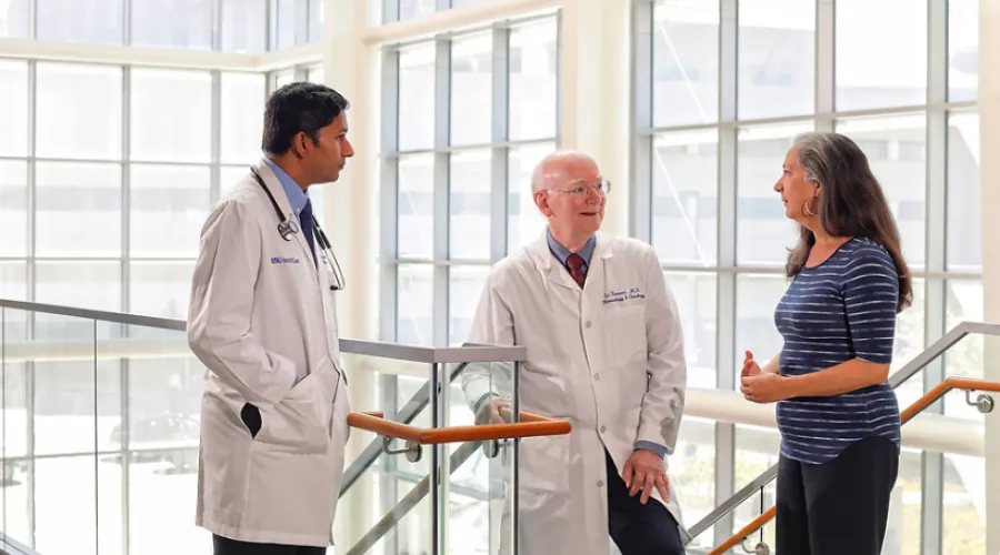 Three UK doctors conversing