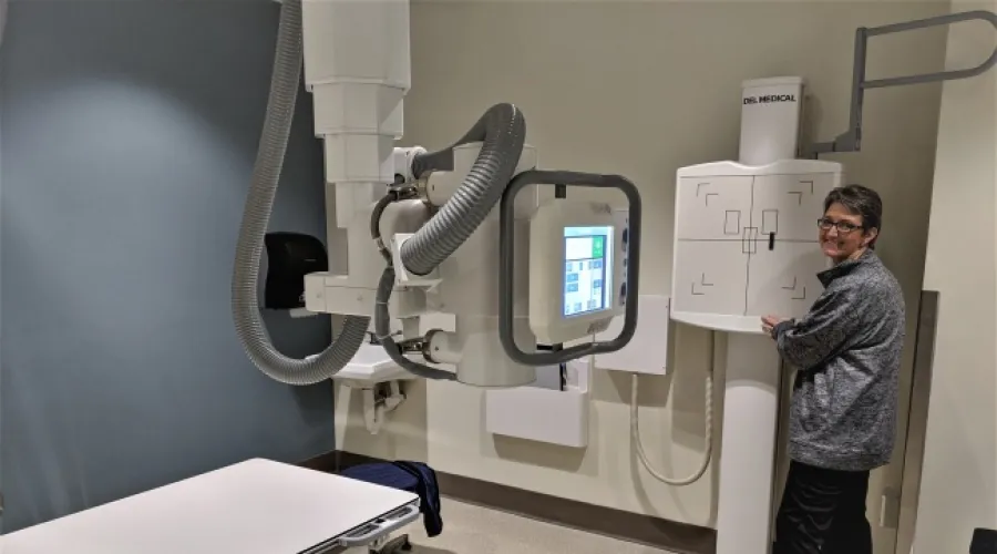 x-ray machine with technician standing to side