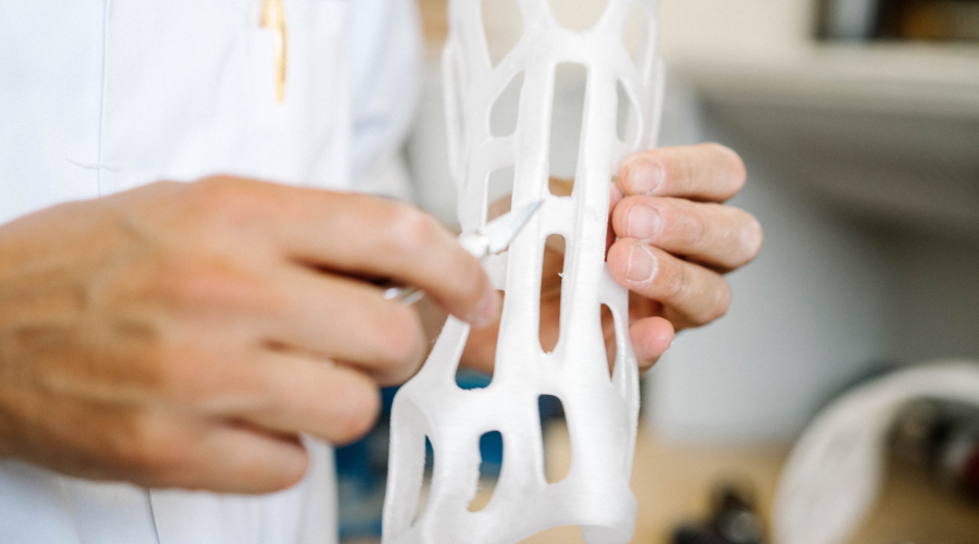 Custom made orthoses printed on a 3D printer being corrected by a orthopedist