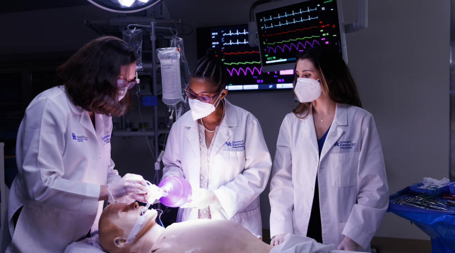professor and students in a simulated surgery