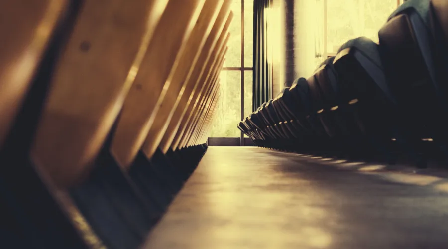 abstract picture of the floor of a lecture or performance hall with the chairs folded up