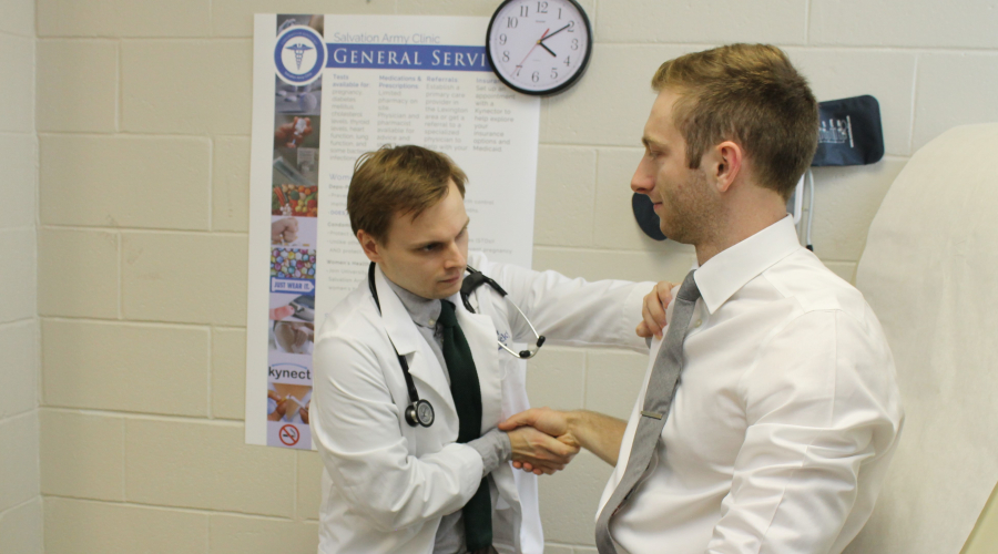 medical student examining "patient"