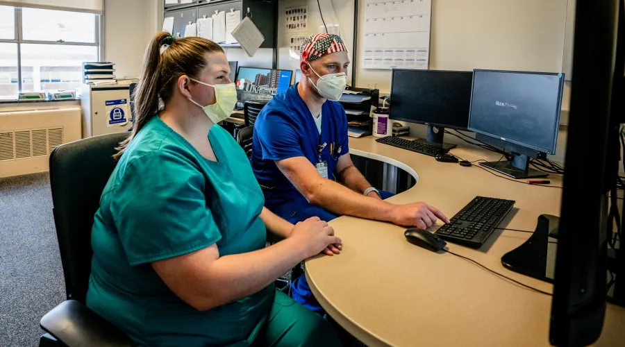 two providers reviewing epilepsy imaging results on a computer screen