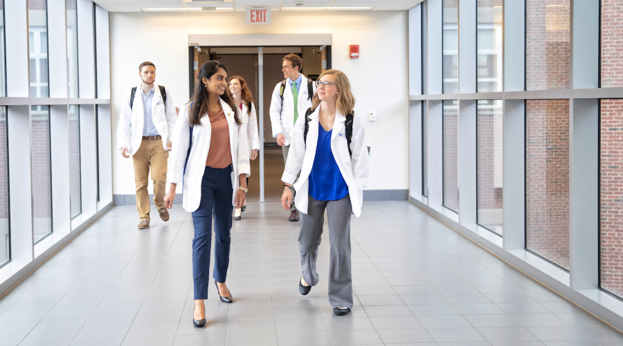 medical students walking down a hallway