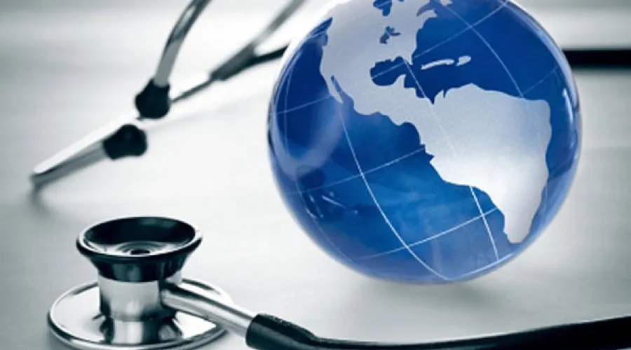 stethoscope laying beside a mini-globe