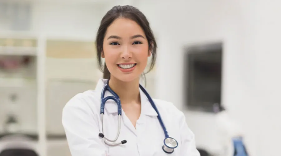 doctor smiling with laboratory in background