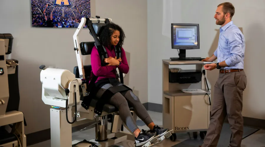 SMRI lab with participant in a machine and provider standing by display screen