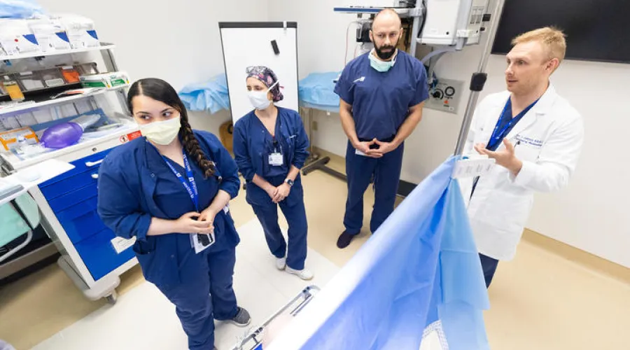 group of anesthesiology residents or fellows receiving instruction from Aric Johnson, MD