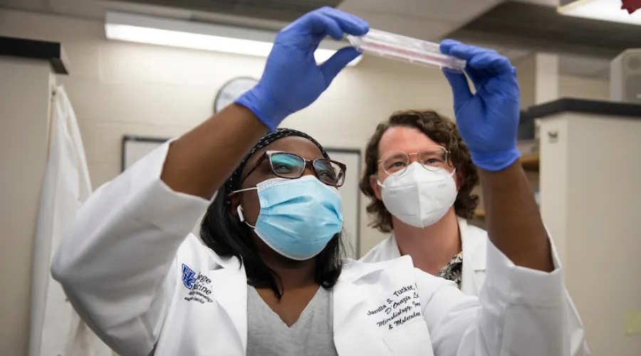 two researchers looking at test results