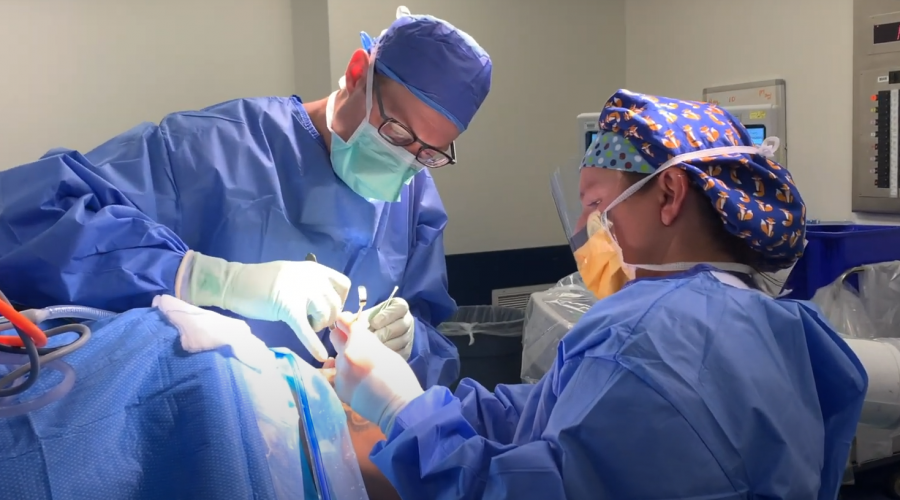Dr. Austin Stone and associate in operating on patient