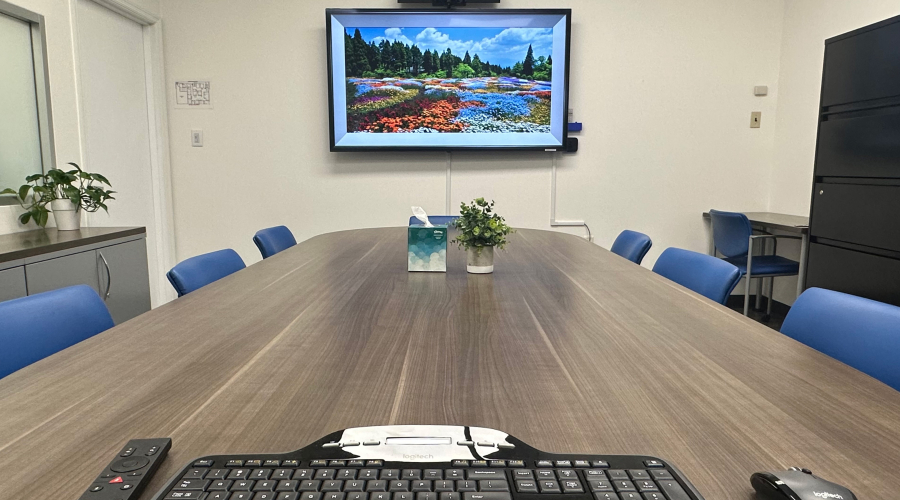 Conference room with monitor, keyboard, and presentation tools
