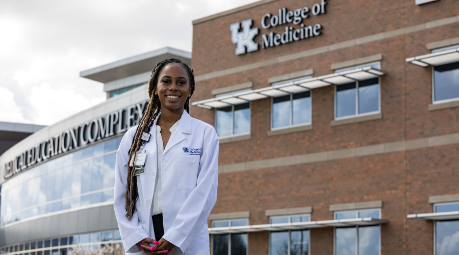 medical student with our bowling green campus building behind her