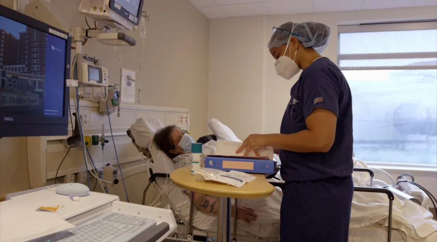 a doctor tending to a patient in a hospital room