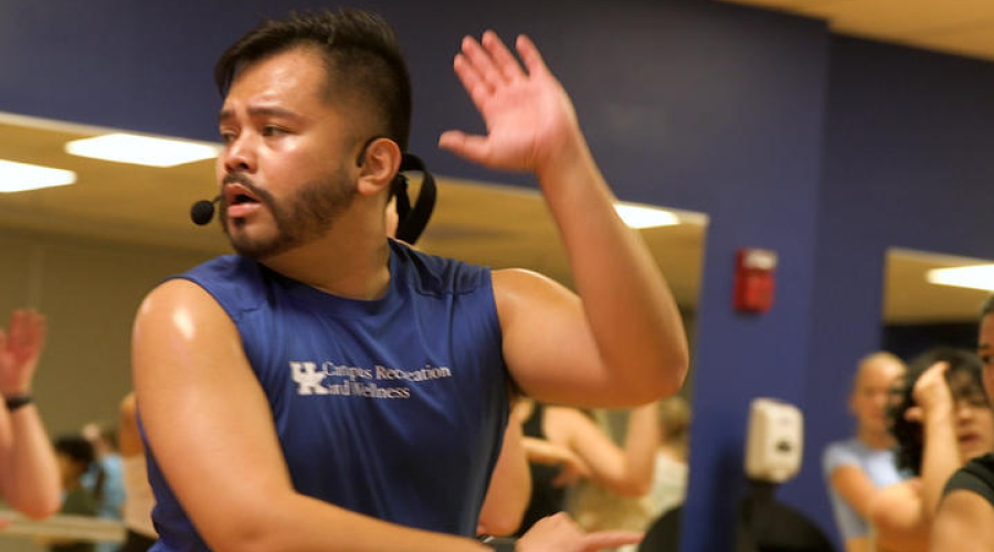 man wearing a tank top leading a fitness class