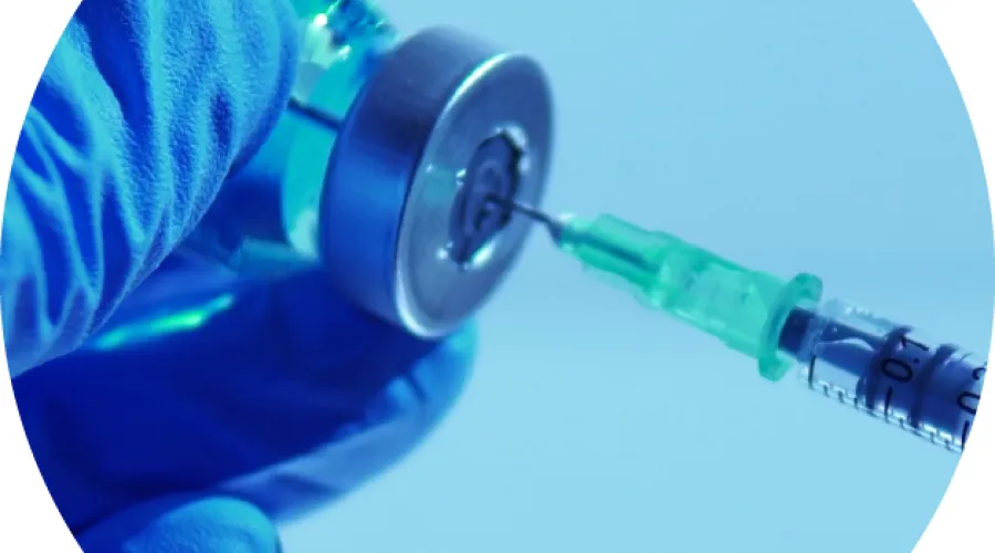 close up of a vaccine syringe and vial