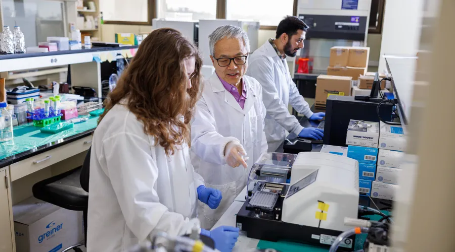 research students in a lab with a professor