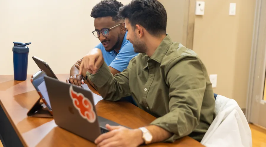 two students looking at screen
