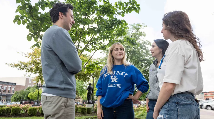 students talking standing together in a park