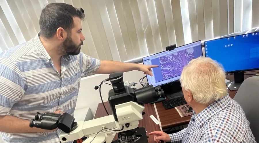 Dr. William O'Connor and fellow Dr. Nashwan Jabbour looking at slides.