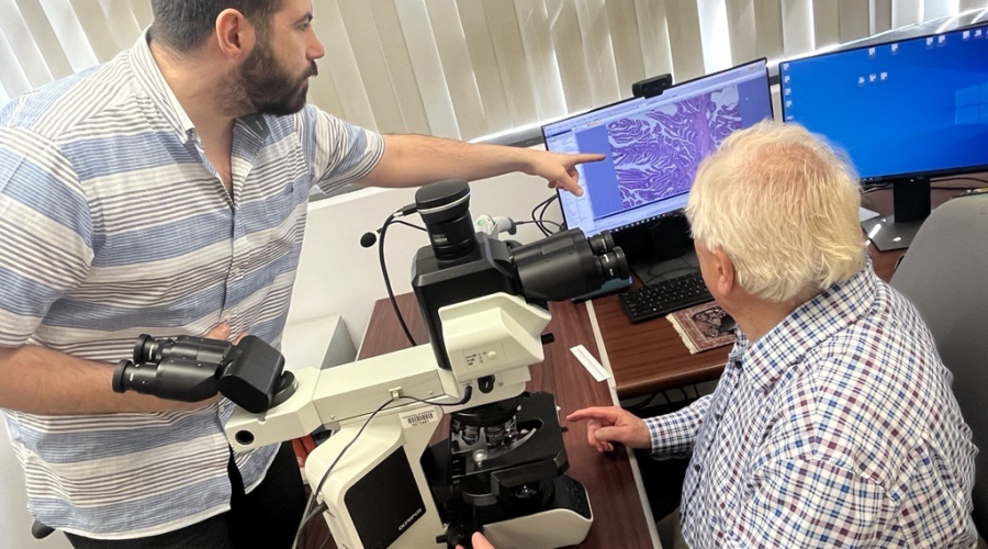 Dr. William O'Connor and fellow Dr. Nashwan Jabbour looking at slides.