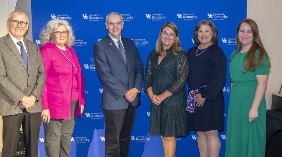 Six people standing in front of a UK background
