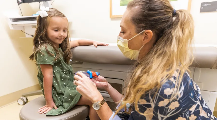 doctor seeing female child in clinical setting